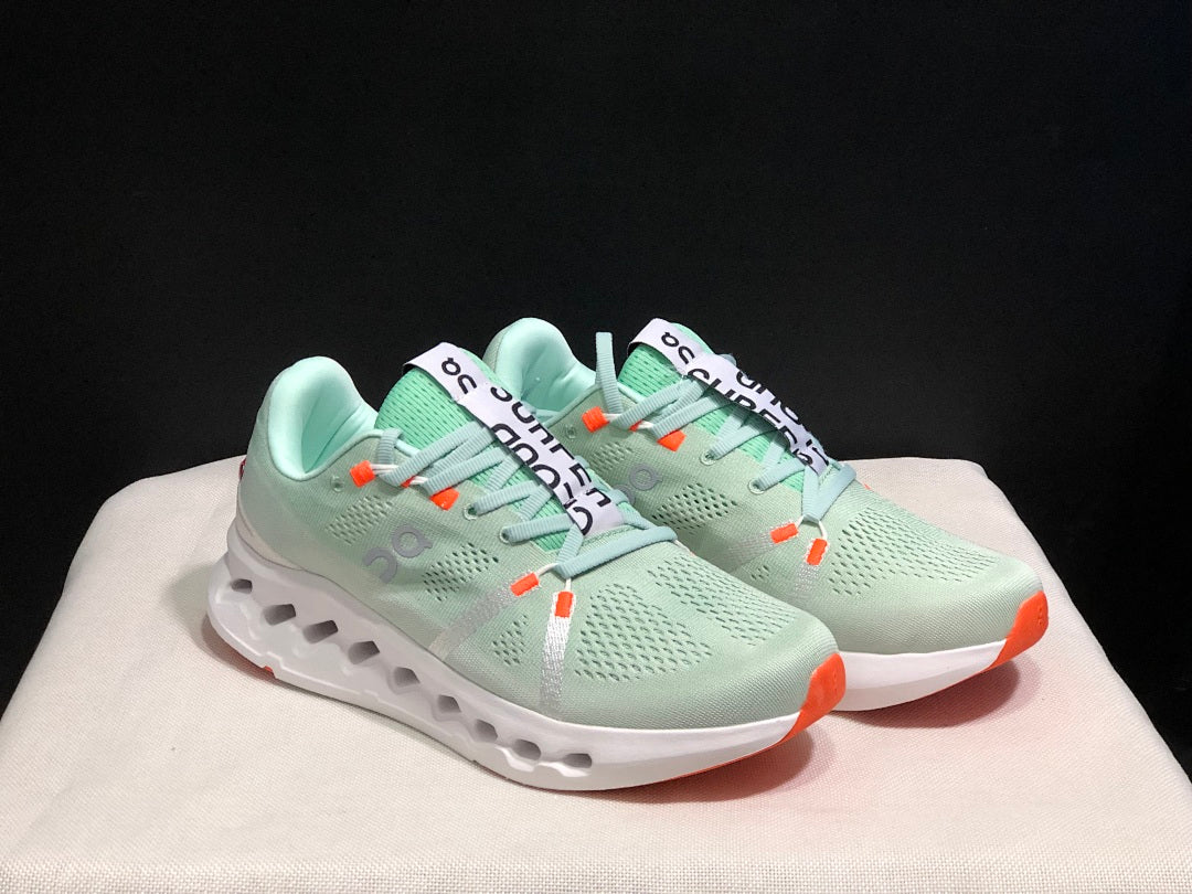 Pale Green and White On Cloudsurfer Sneakers - product image from the listing.