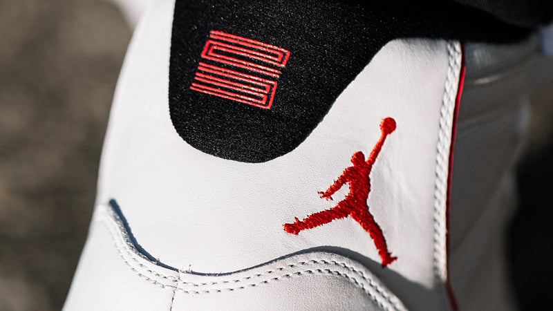 Air Jordan 11 Platinum Tint White High-Top Sneakers - product image from the listing.