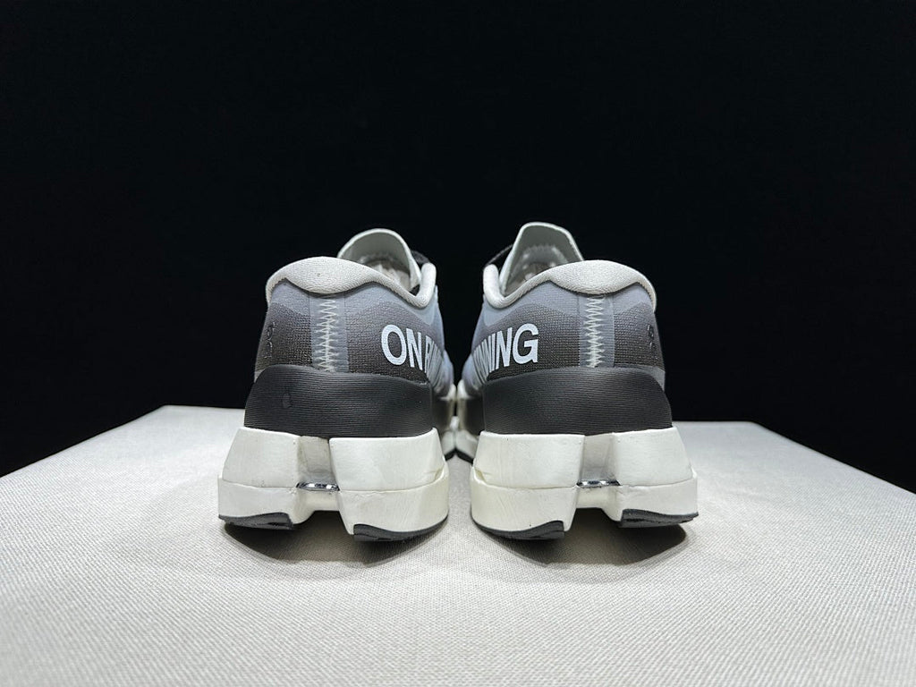 On Cloudboom Max Running Shoes, in White and Black - product image from the listing.