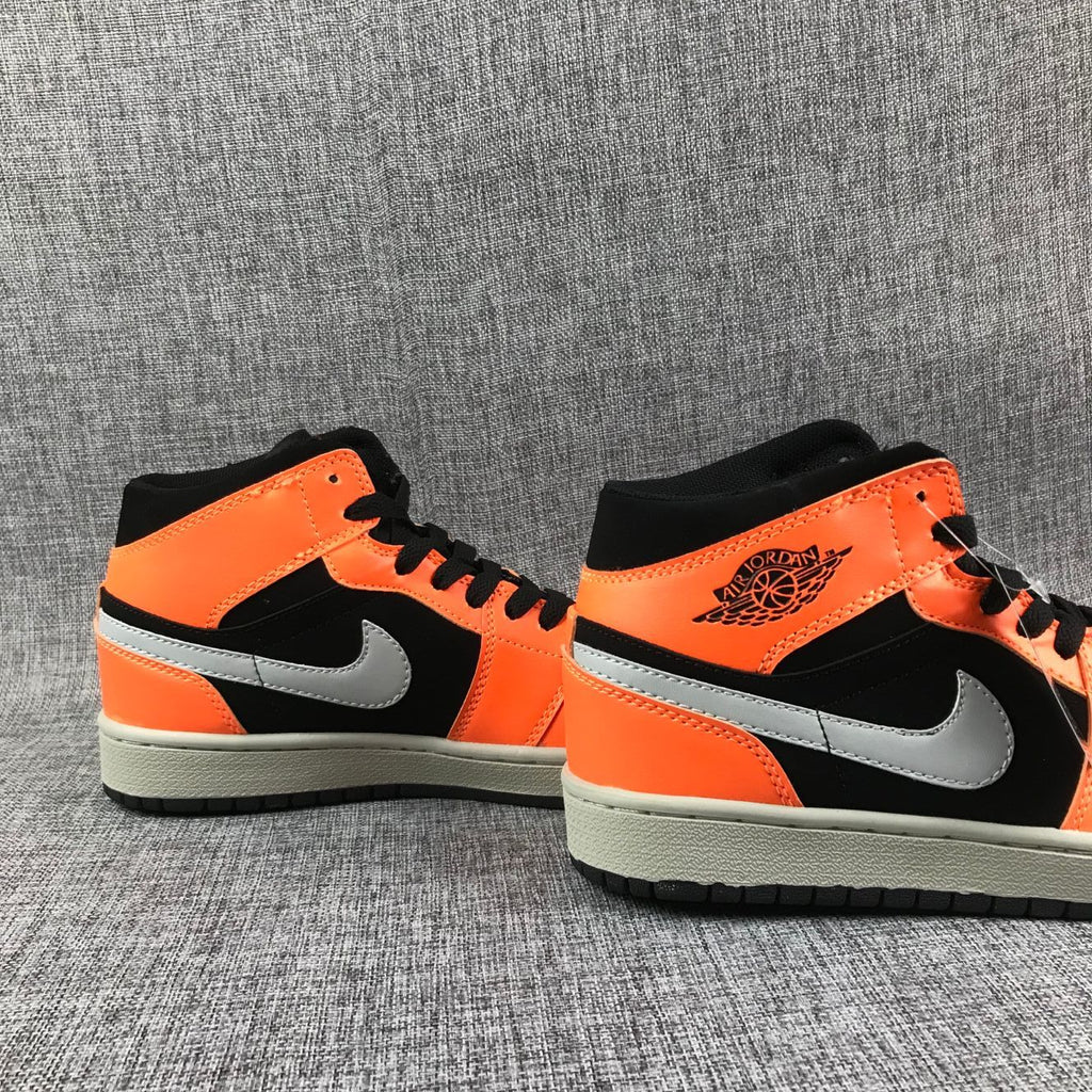 Air Jordan 1 Mid Sneakers in Black Orange 554724-062 - product image from the listing.