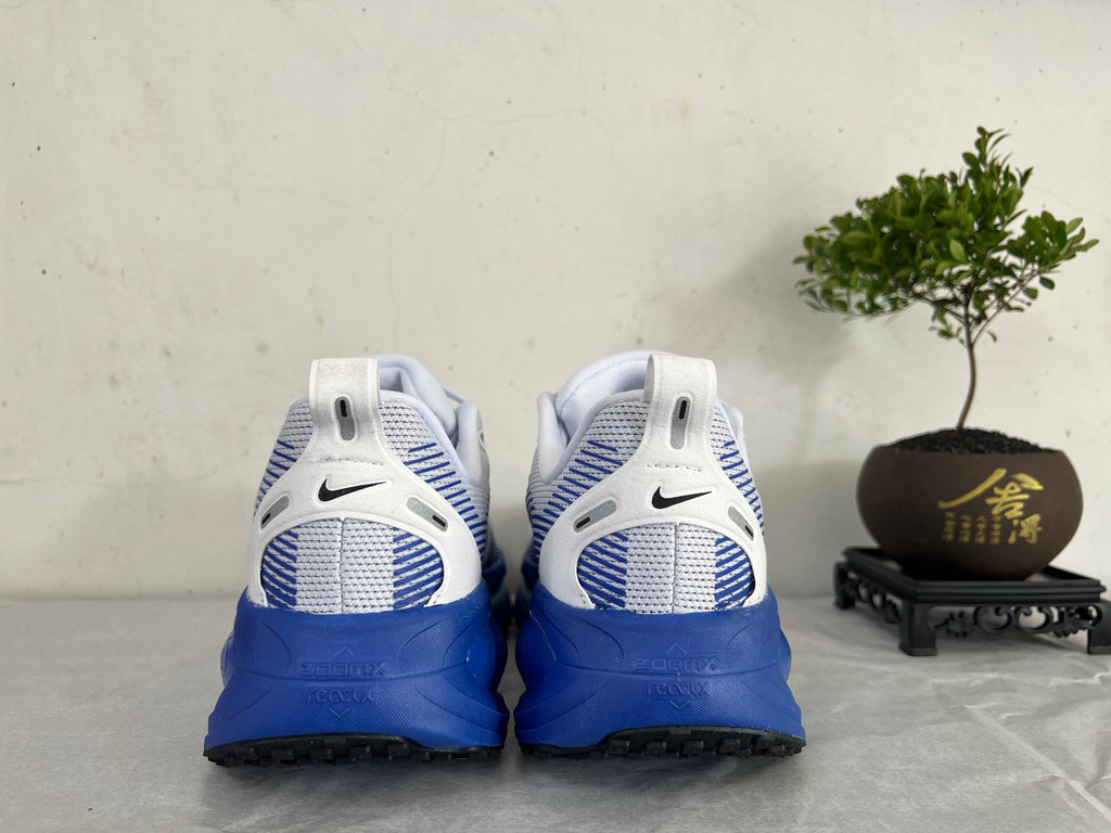 Nike Vomero 18 Running Shoes, in White and Blue - product image from the listing.