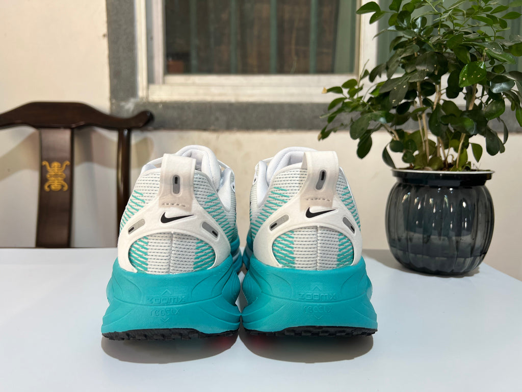 Nike Vomero 18 Running Shoes in White and Turquoise - product image from the listing.