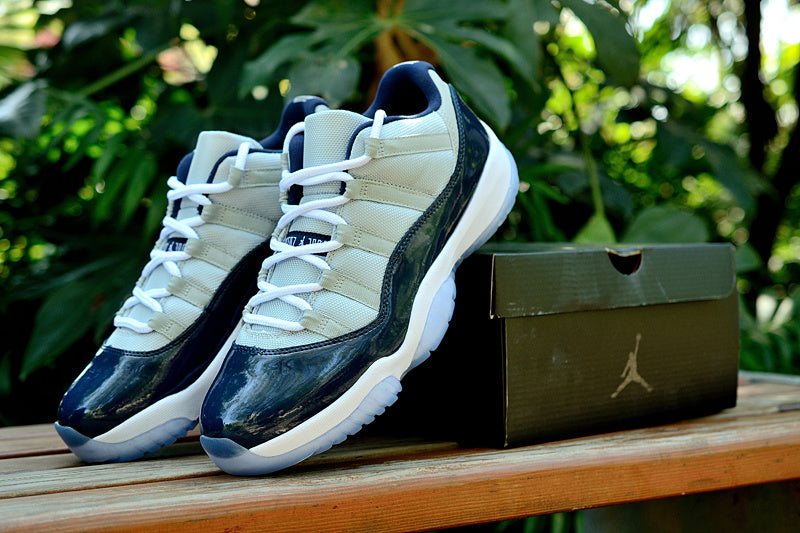 Air Jordan 11 Retro Low Sneakers, White and Navy - product image from the listing.
