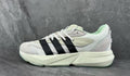 White and Black Adidas Lightstrike Low-Top Sneakers - product image from the listing.