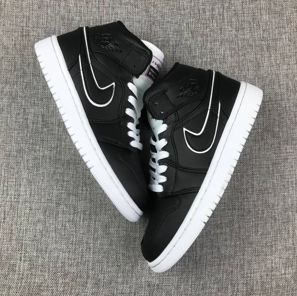 Air Jordan 1 Mid Sneakers in Black and White 852542-016 - product image from the listing.