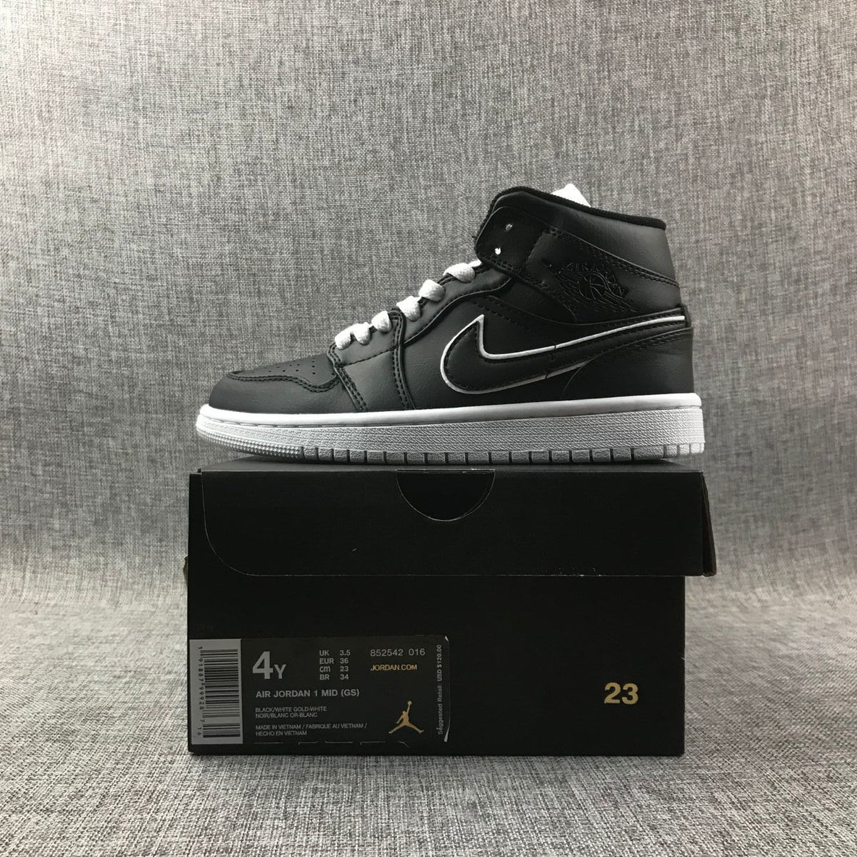 Air Jordan 1 Mid Sneakers in Black and White 852542-016 - product image from the listing.
