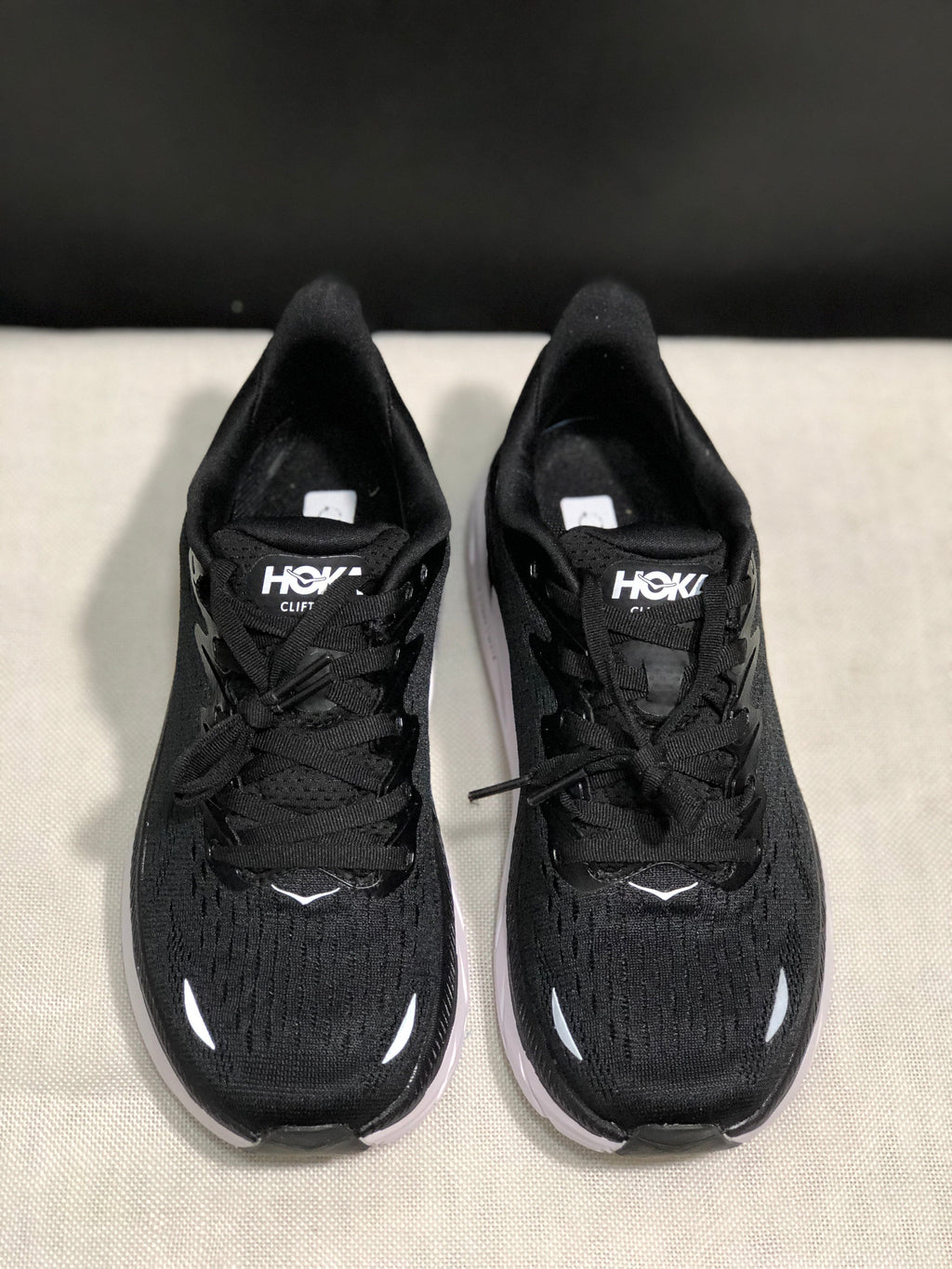 HOKA Clifton 8 Running Shoes, in Black and White - product image from the listing.