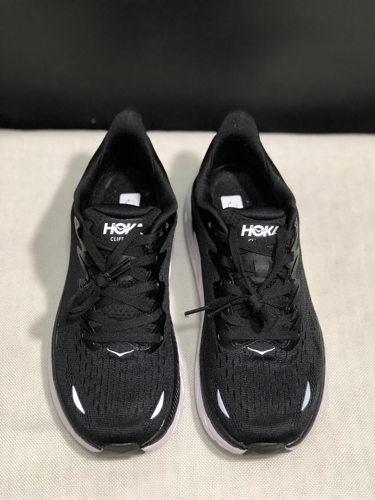 HOKA Clifton 8 Running Shoes, in Black and White - product image from the listing.