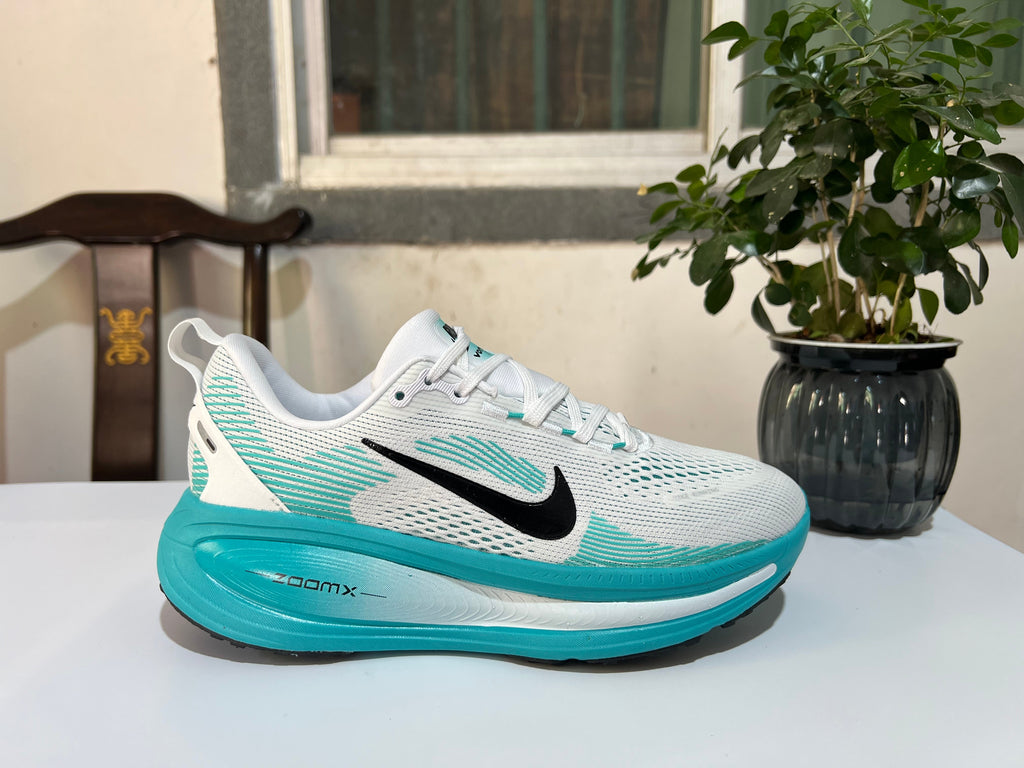 Nike Vomero 18 Running Shoes in White and Turquoise - product image from the listing.