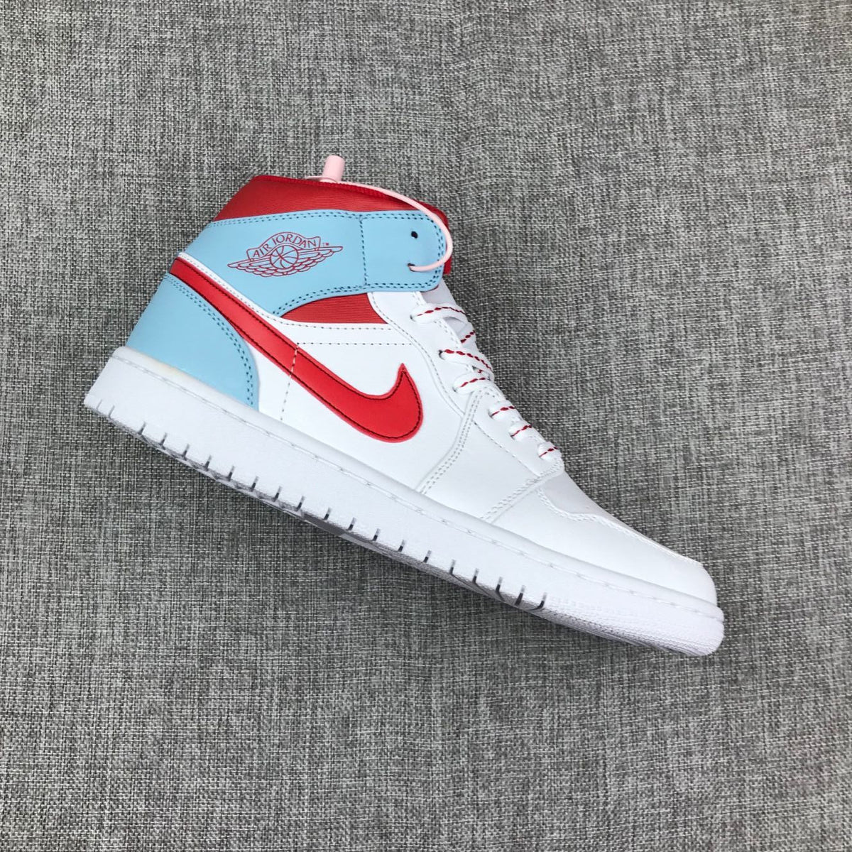 Air Jordan 1 Mid Sneakers in Ice Blue White and Red 555112-104 - product image from the listing.