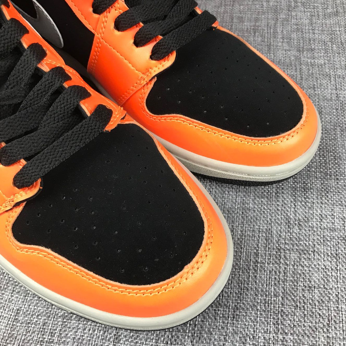 Air Jordan 1 Mid Sneakers in Black Orange 554724-062 - product image from the listing.