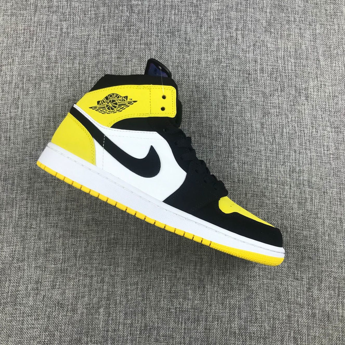 Black Yellow Toe Sneakers - Air Jordan 1 Mid SE 852542-071 - product image from the listing.
