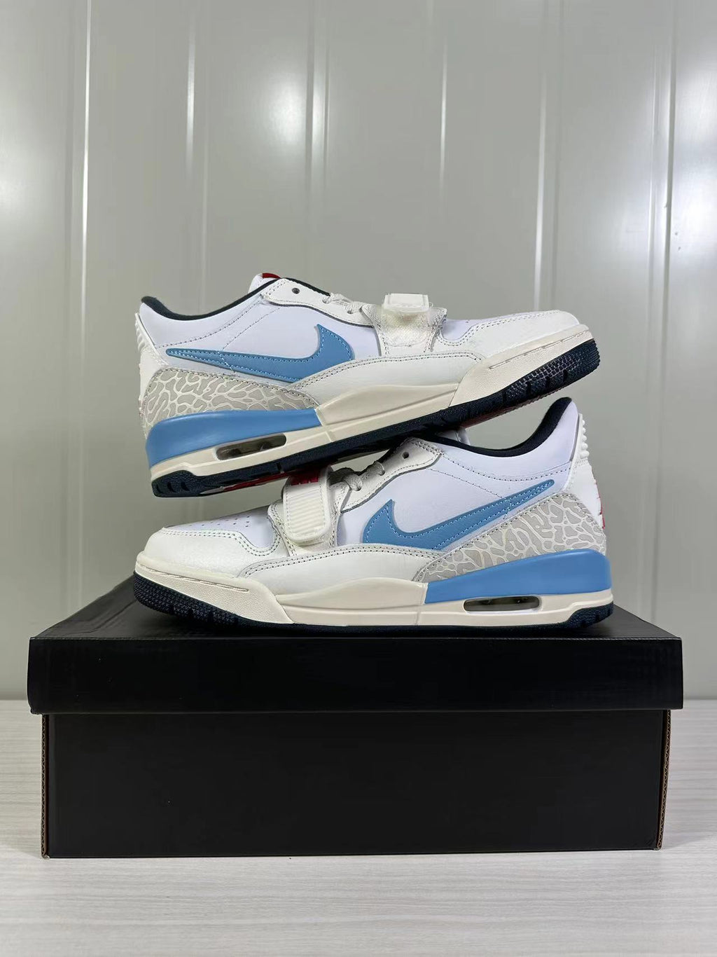 Jordan Legacy 312 Low in White Blue Red HM3709-141 - product image from the listing.