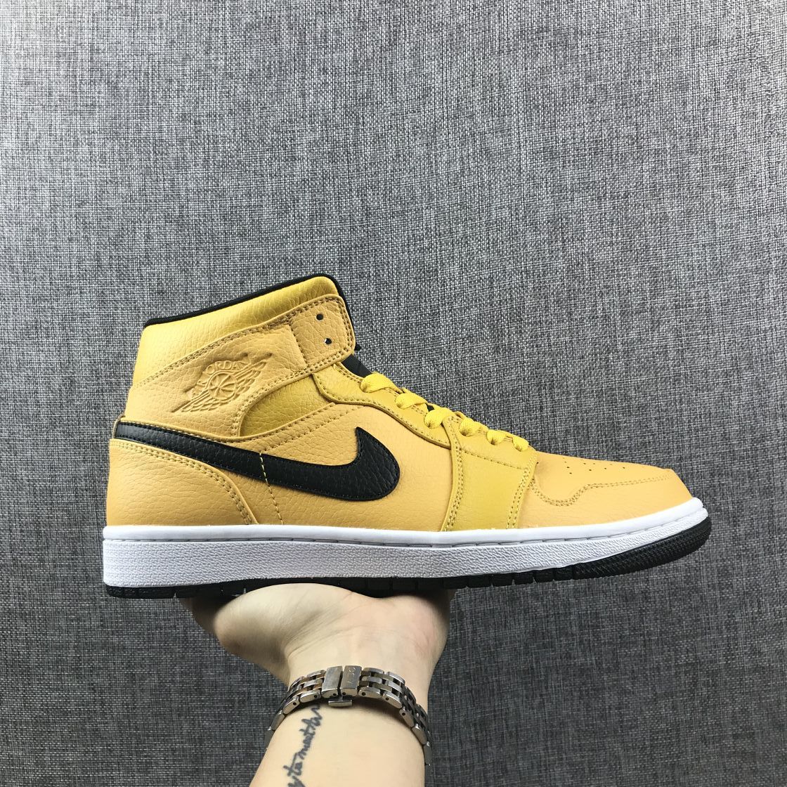 Air Jordan 1 Mid Yellow Ochre Sneakers in Black 554724-700 - product image from the listing.