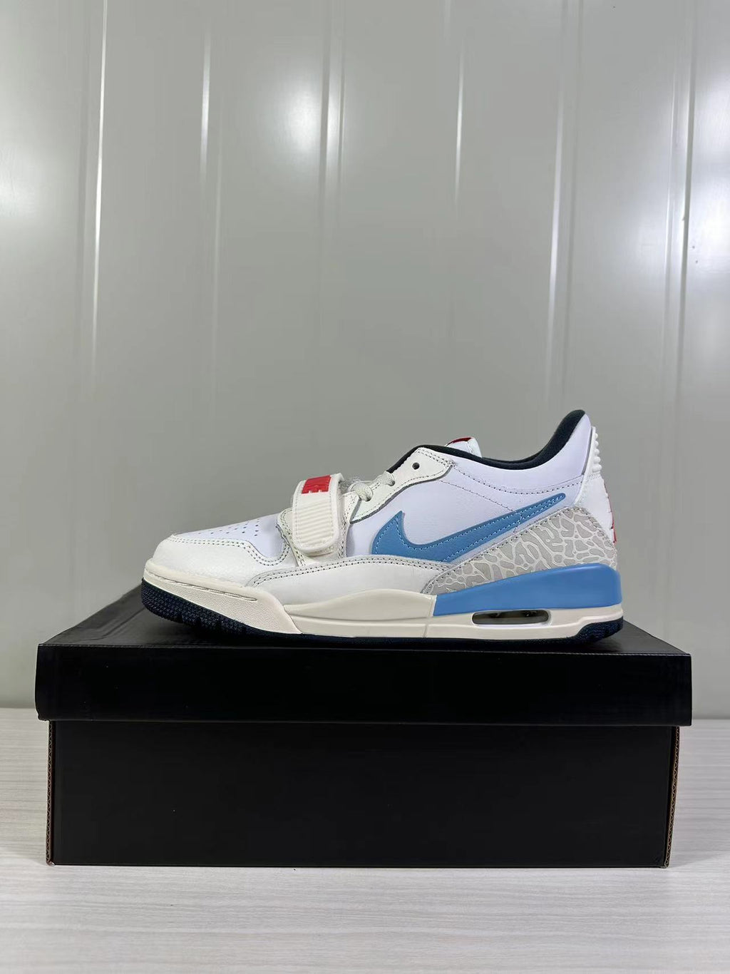 Jordan Legacy 312 Low in White Blue Red HM3709-141 - product image from the listing.
