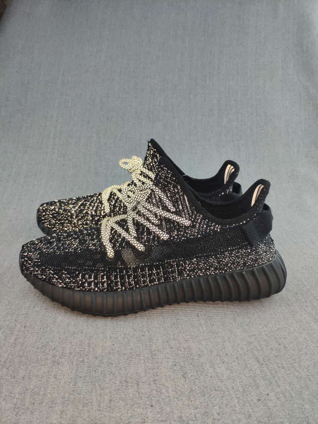 Black and Cream Yeezy 350 V2 Knit Sneakers - product image from the listing.