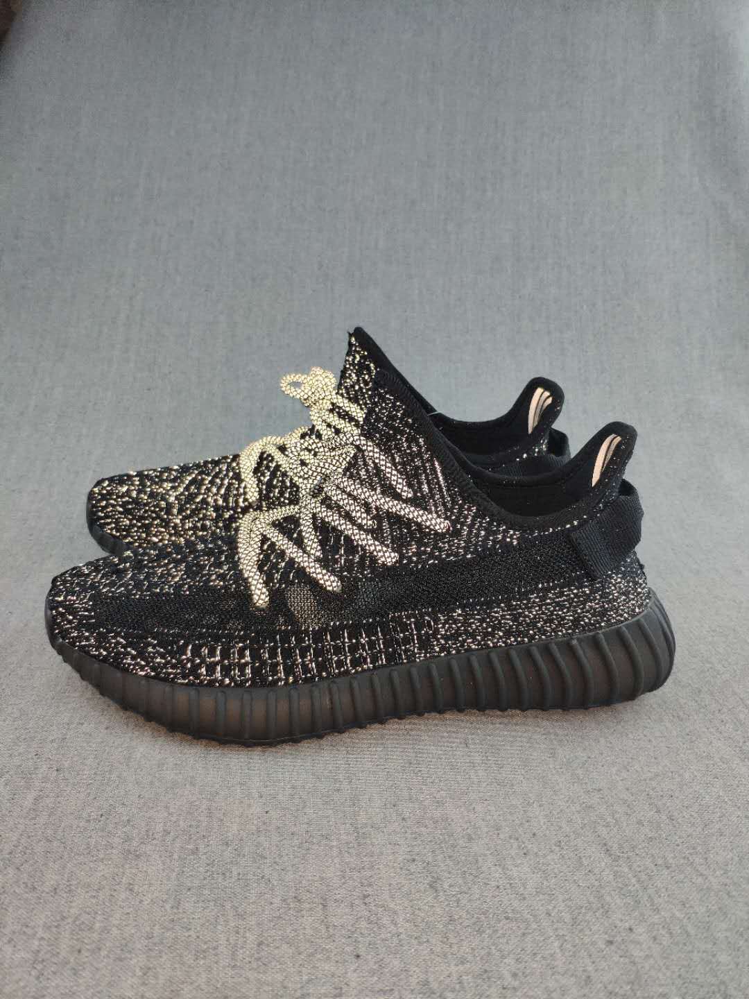 Black and Cream Yeezy 350 V2 Knit Sneakers - product image from the listing.