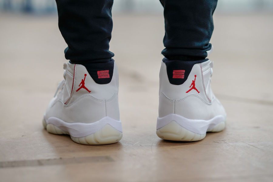 Air Jordan 11 Platinum Tint White High-Top Sneakers - product image from the listing.