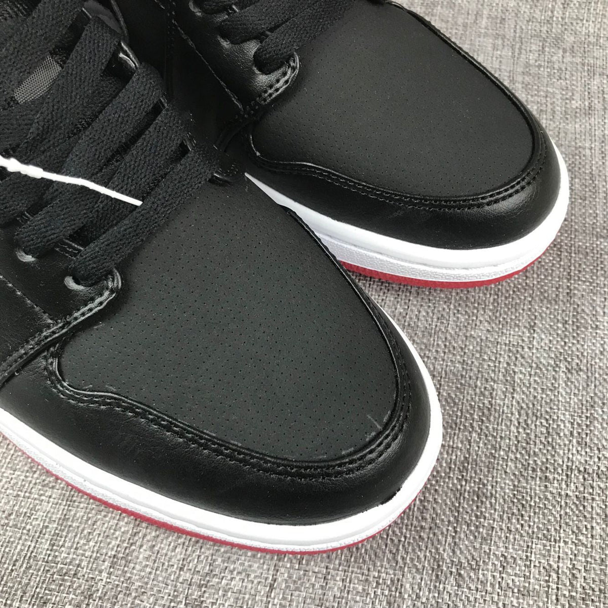 Air Jordan 1 Mid High-Top Sneakers in Black Red White - product image from the listing.