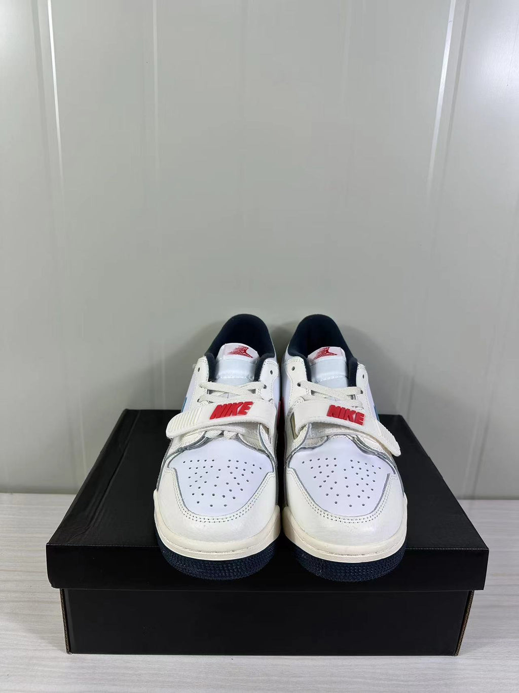 Jordan Legacy 312 Low in White Blue Red HM3709-141 - product image from the listing.