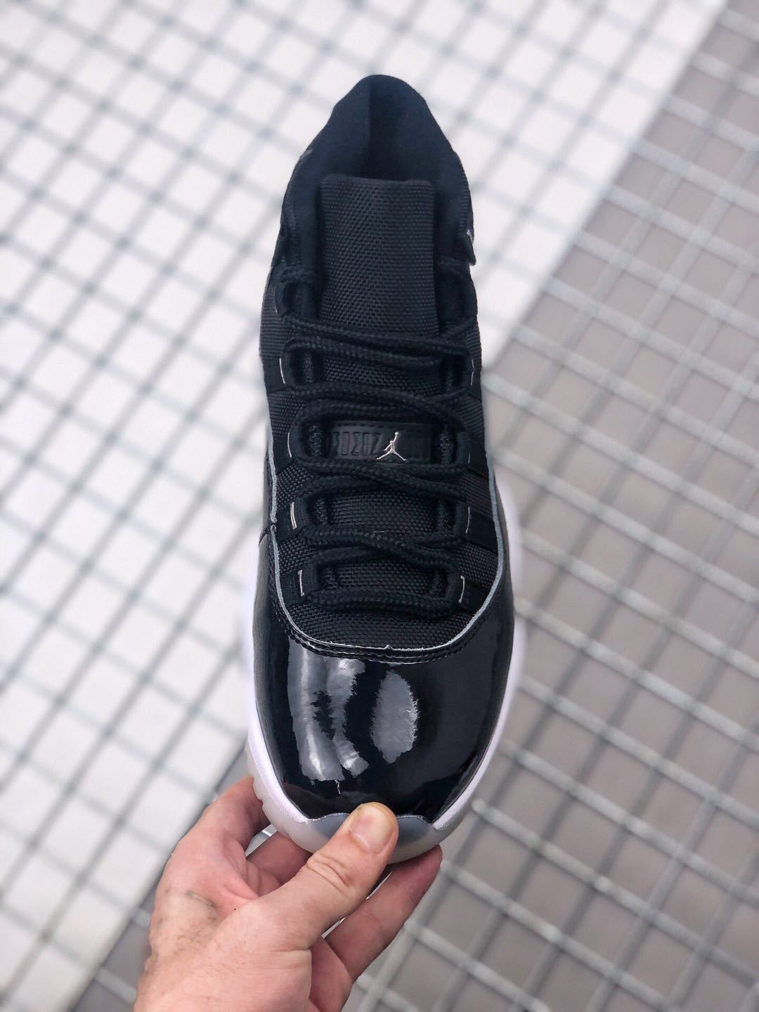 Air Jordan 11 Silver Eyelets Black White Sneakers - product image from the listing.