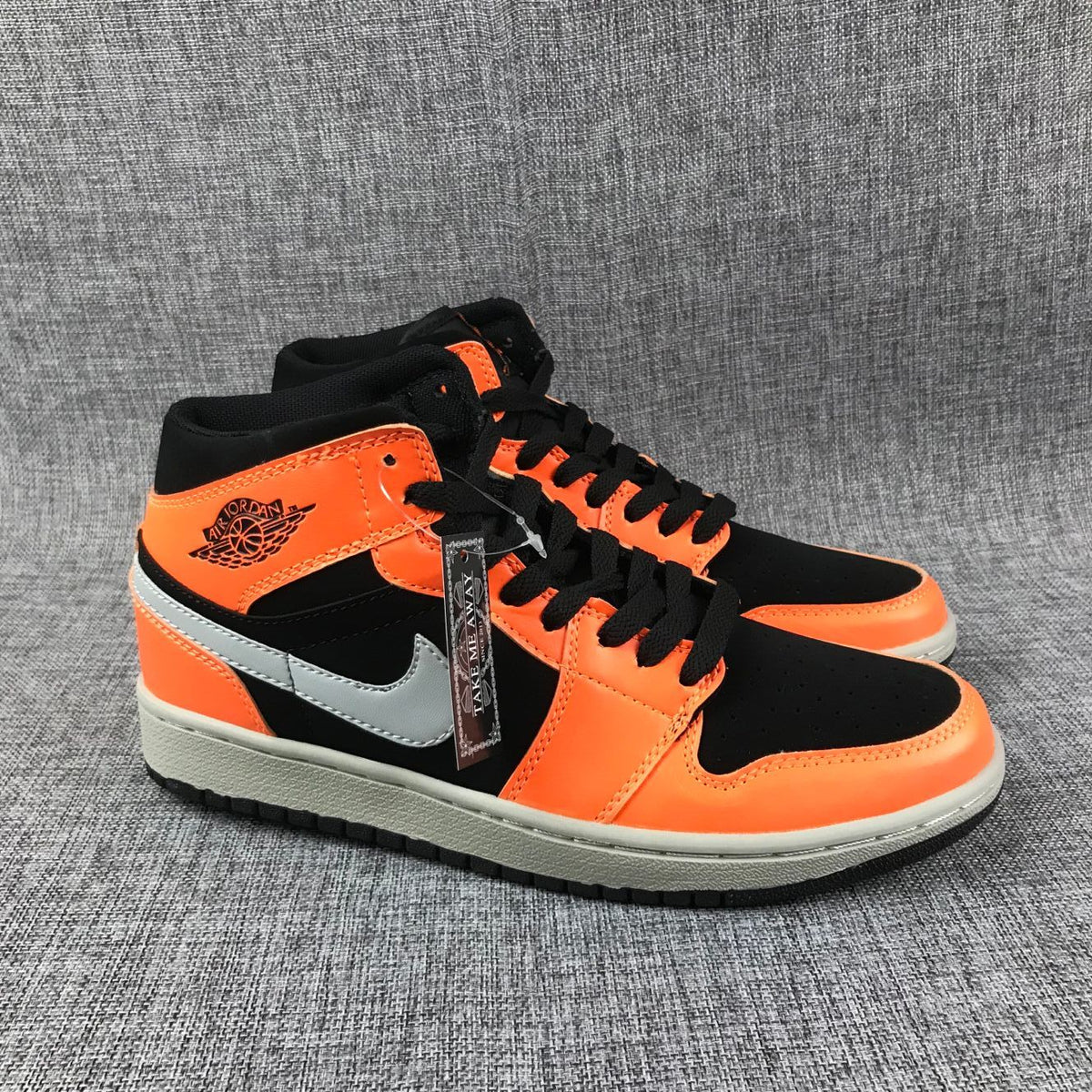 Air Jordan 1 Mid Sneakers in Black Orange 554724-062 - product image from the listing.