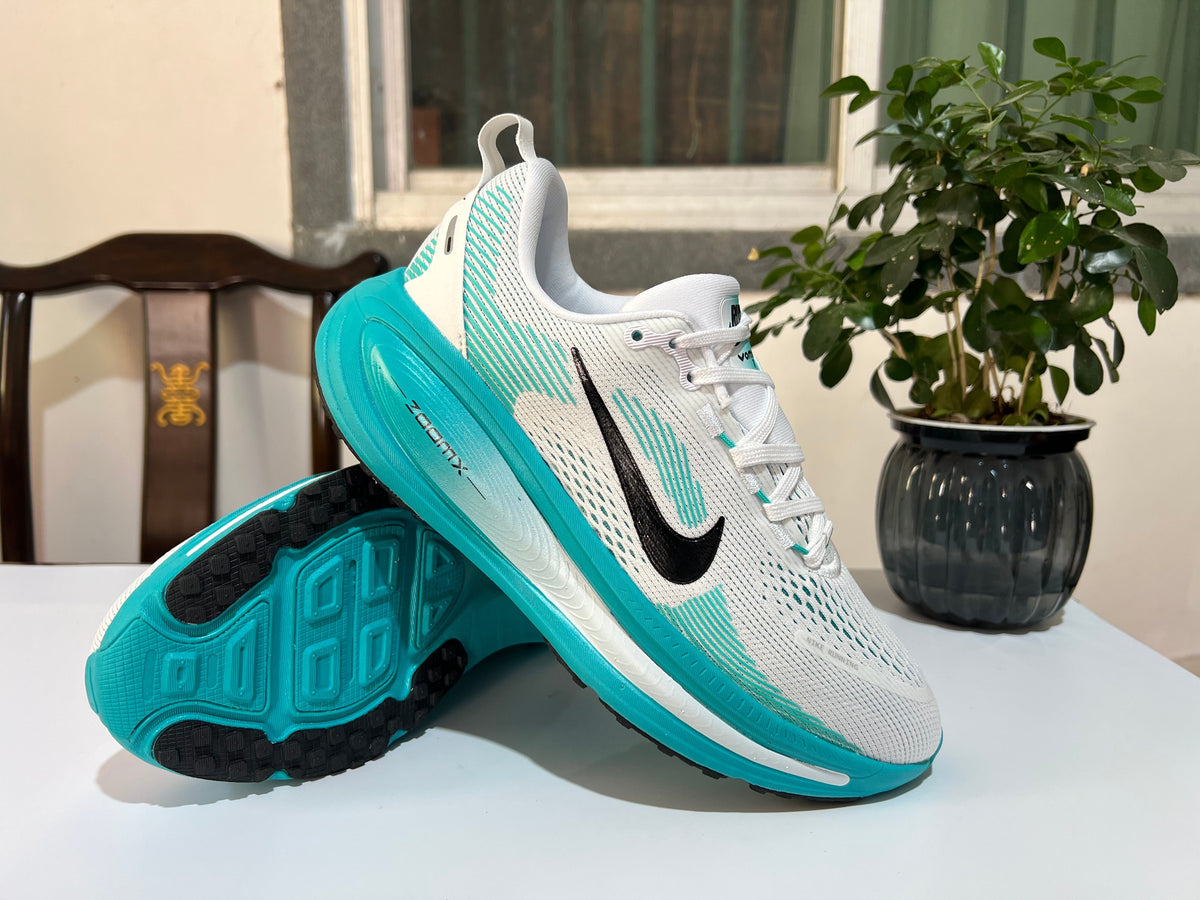 Nike Vomero 18 Running Shoes in White and Turquoise - product image from the listing.