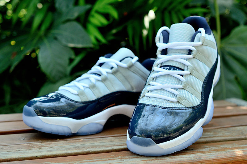 Air Jordan 11 Retro Low Sneakers, White and Navy - product image from the listing.