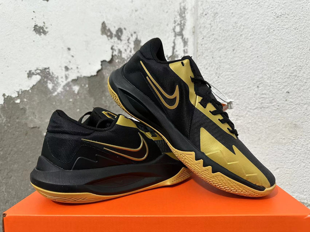 Nike Basketball Sneakers in Black and Gold - product image from the listing.