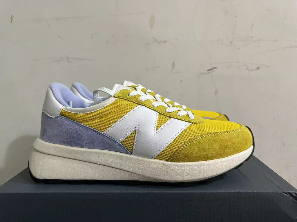 New Balance U370 Trainers in Yellow and Lavender - product image from the listing.