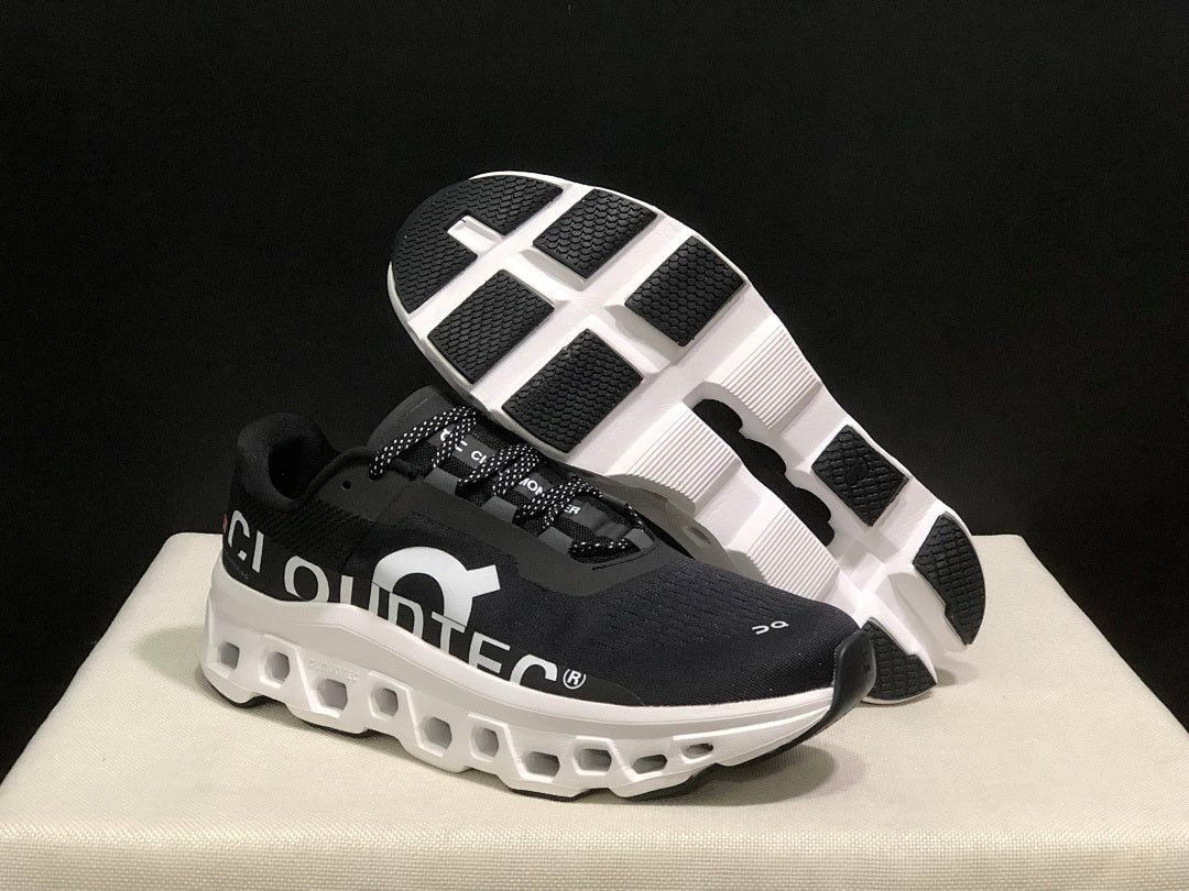 On Cloudmonster Running Sneakers in Black and White - product image from the listing.