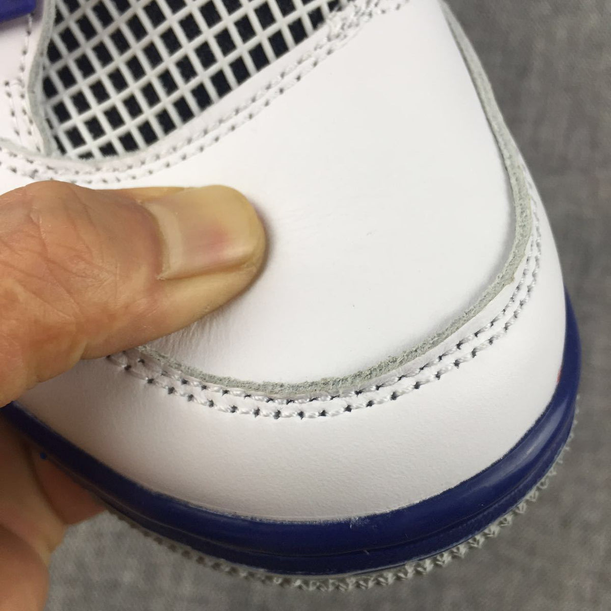 Air Jordan 4 Sneakers in White, Black and Blue - product image from the listing.