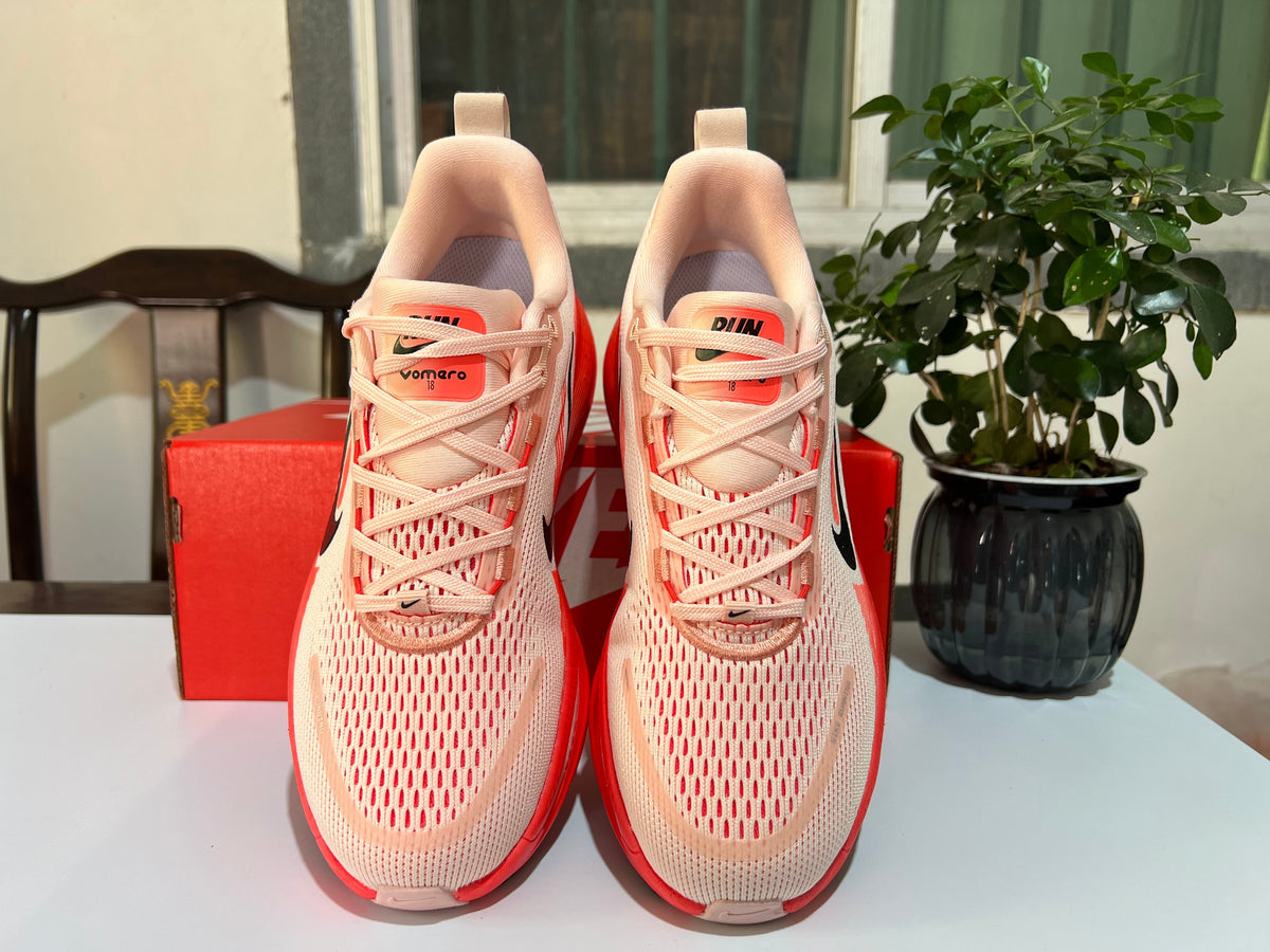 Cream and Coral Nike Vomero 18 Running Shoes - product image from the listing.