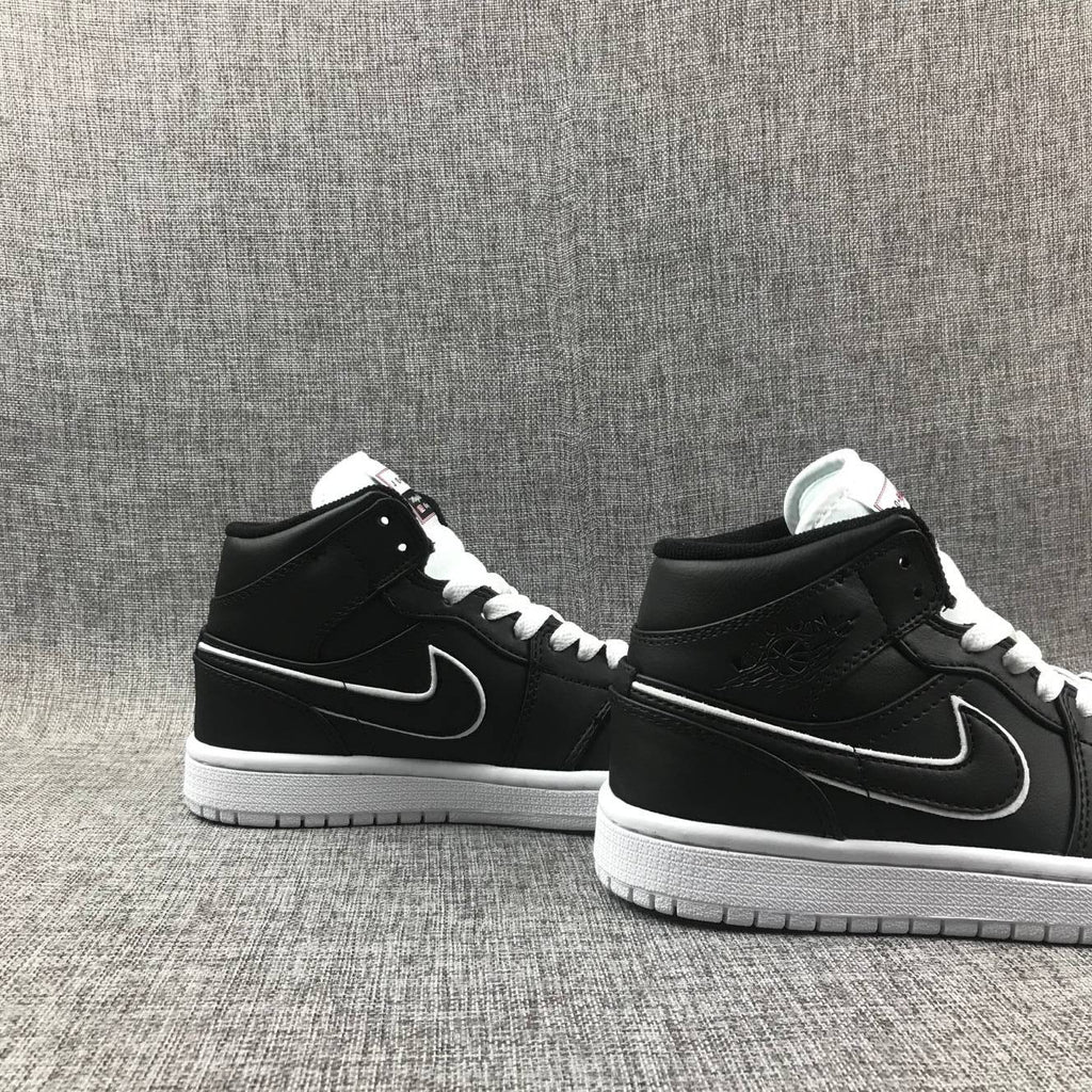 Air Jordan 1 Mid Sneakers in Black and White 852542-016 - product image from the listing.