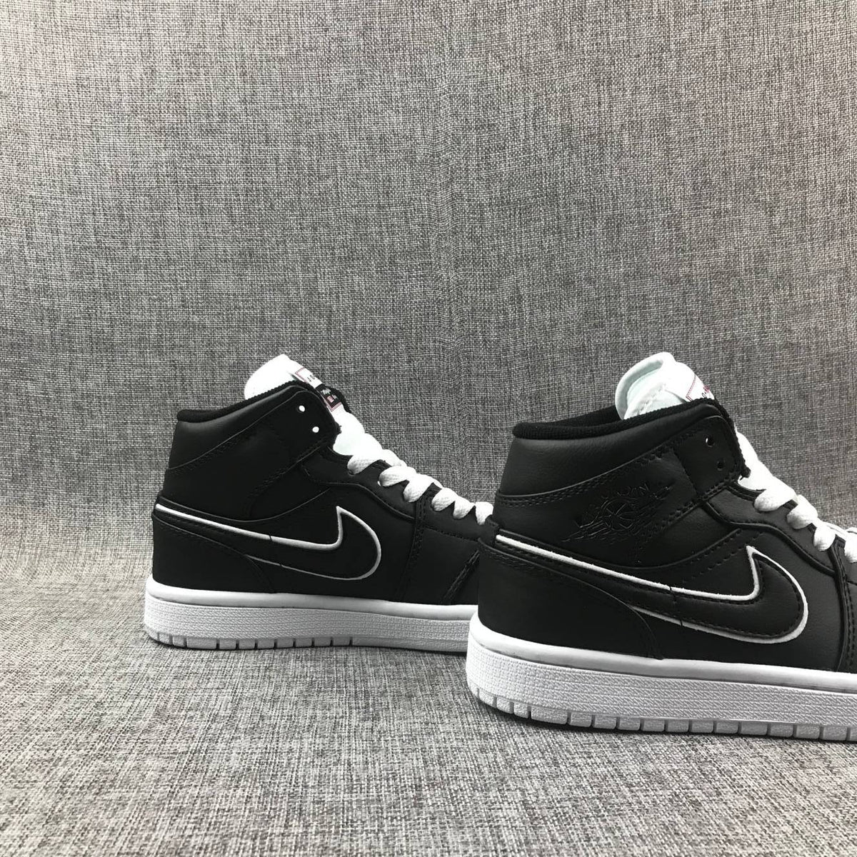 Air Jordan 1 Mid Sneakers in Black and White 852542-016 - product image from the listing.