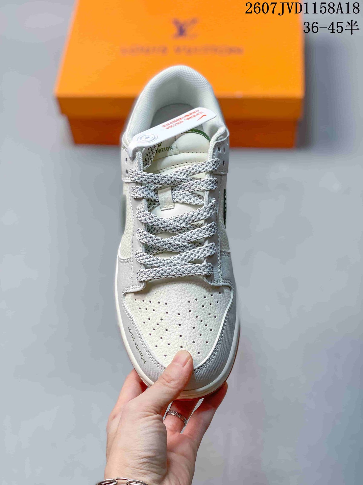 Nike SB Dunk Low Sneakers in White Green Gum 2607JVD1158A18 - product image from the listing.
