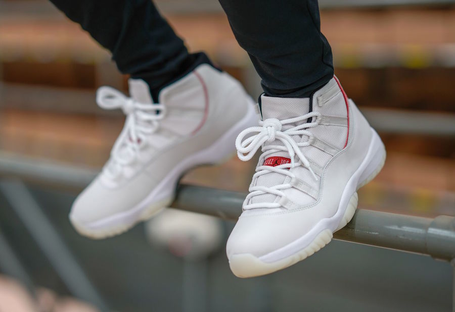 Air Jordan 11 Platinum Tint White High-Top Sneakers - product image from the listing.