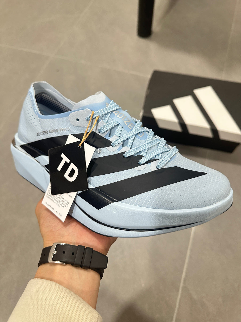 adidas Adizero Adios Pro Running Shoes, in Light Blue and Black - product image from the listing.