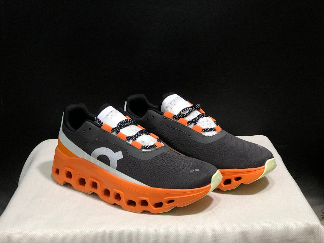 On Cloudmonster Running Shoes in Black Orange - product image from the listing.