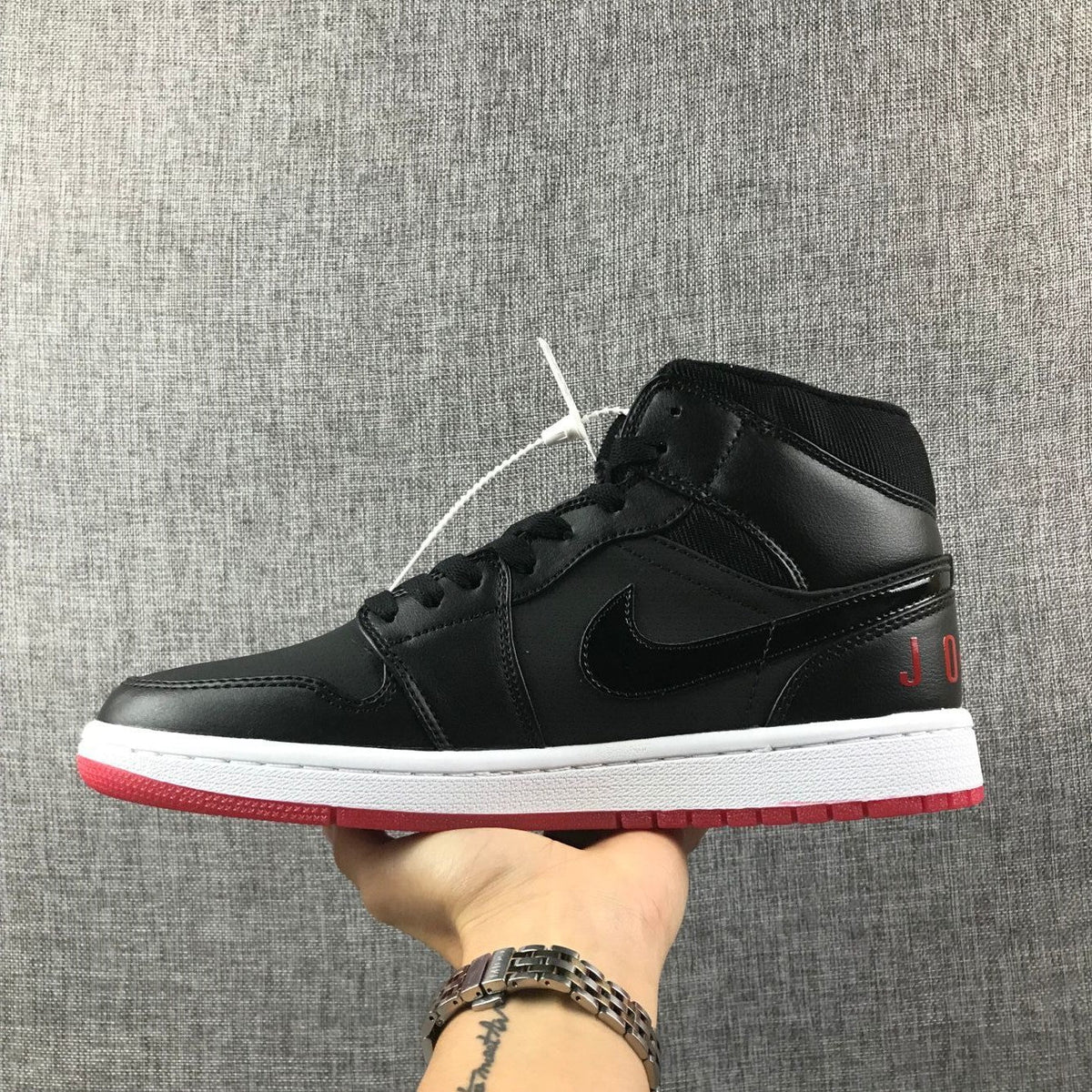 Air Jordan 1 Mid High-Top Sneakers in Black Red White - product image from the listing.
