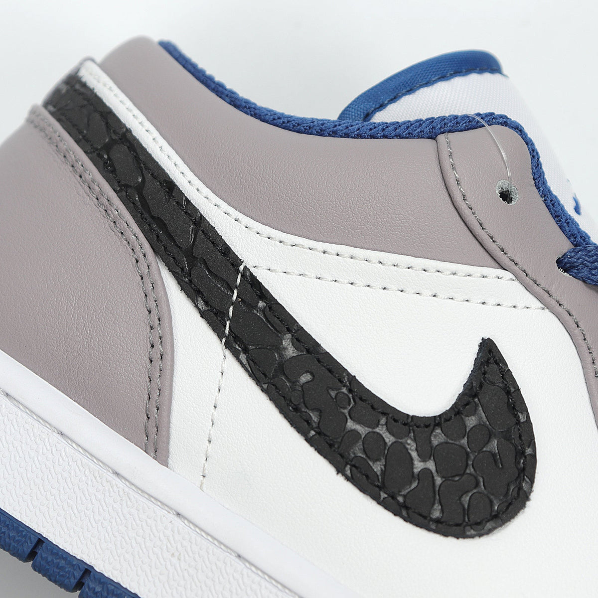 Jordan 1 Low Sneakers in White Grey Blue 553558-103 - product image from the listing.