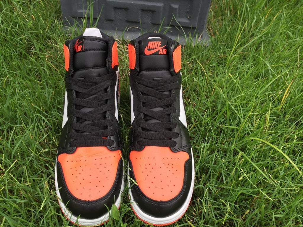 Women's Jordan 1 High Black Orange White Sneakers - product image from the listing.