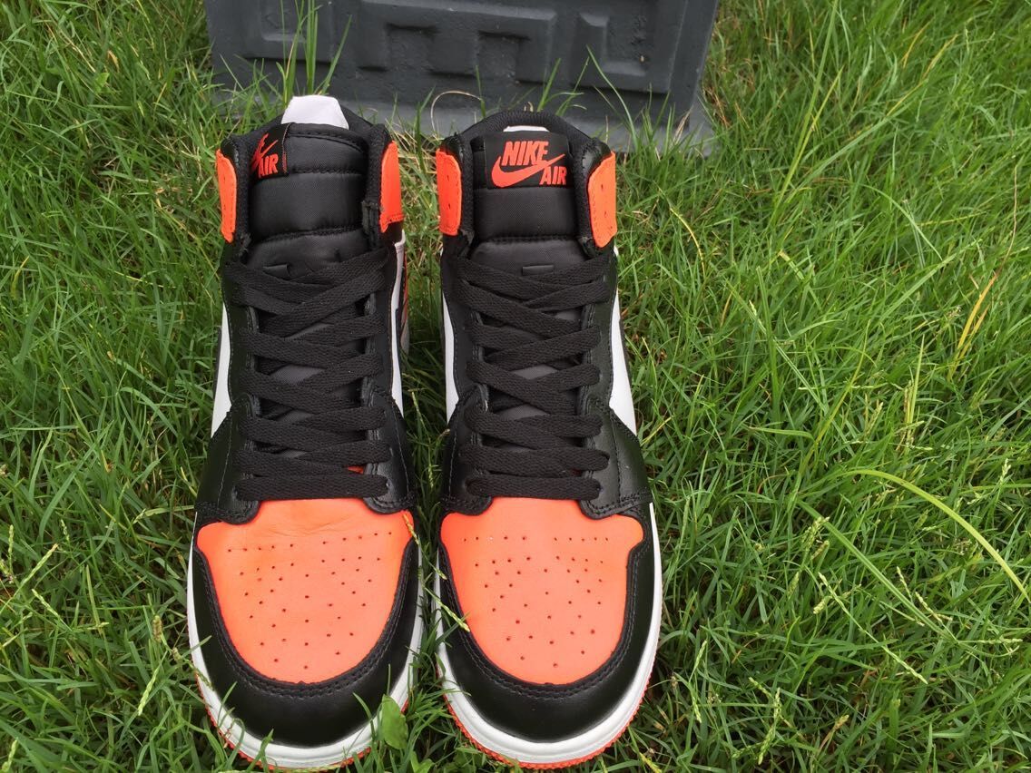 Women's Jordan 1 High Black Orange White Sneakers - product image from the listing.