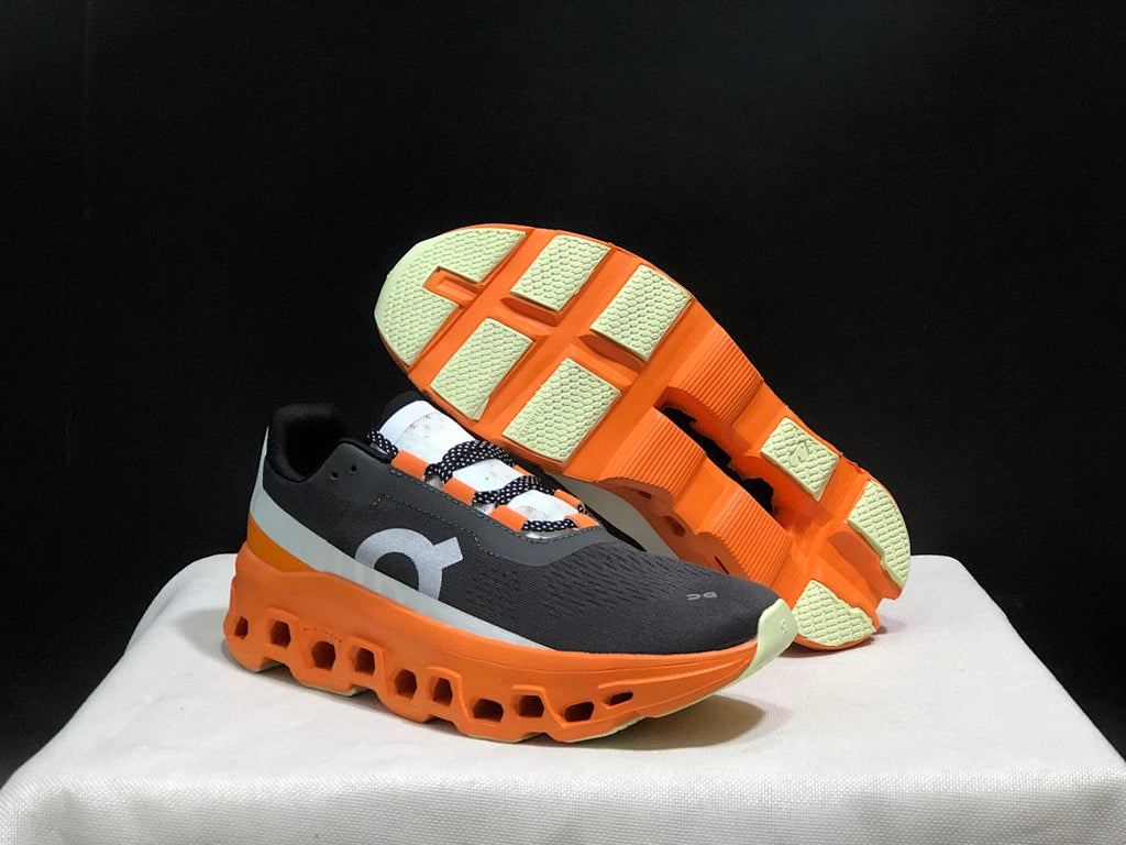 On Cloudmonster Running Shoes in Black Orange - product image from the listing.