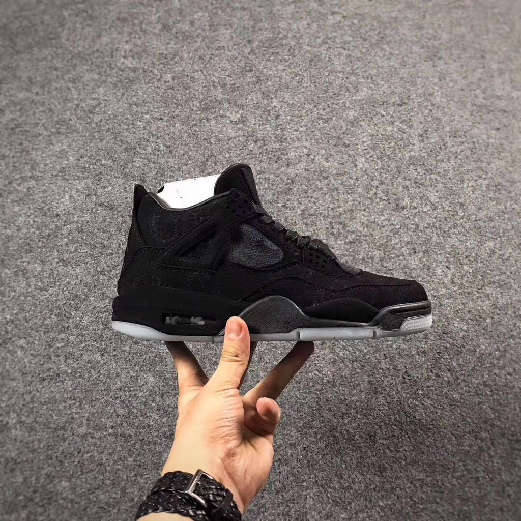 Jordan 4 KAWS Graffiti High-Top Sneakers in Black - product image from the listing.