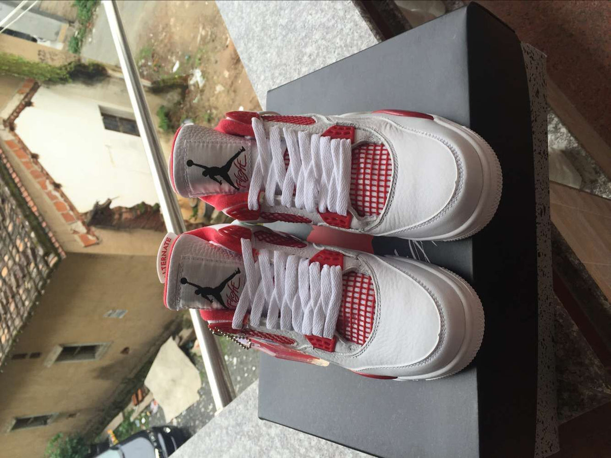 Jordan 4 Retro High-Top Sneakers in White and Red - product image from the listing.