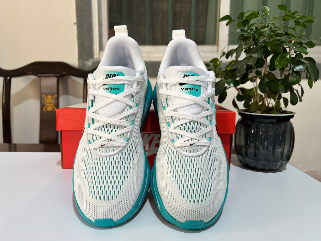 Nike Vomero 18 Running Shoes in White and Turquoise - product image from the listing.
