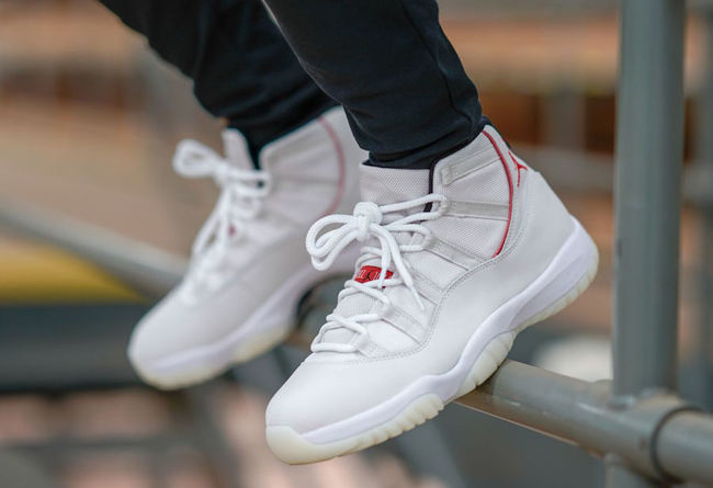 Air Jordan 11 Platinum Tint White High-Top Sneakers - product image from the listing.