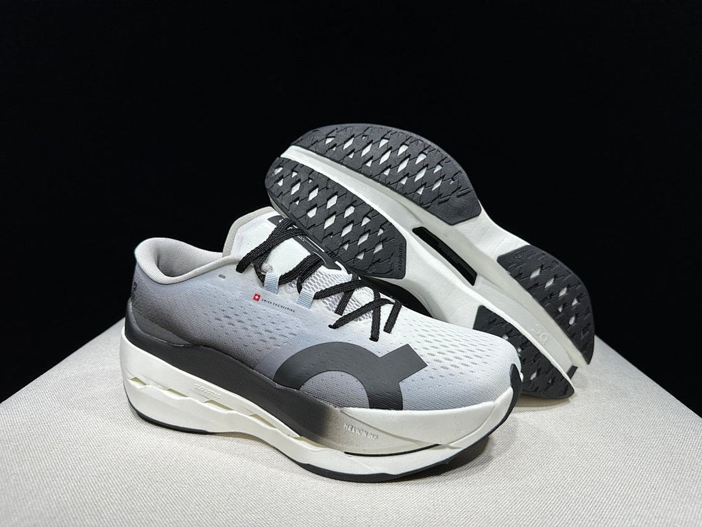 On Cloudboom Max Running Shoes, in White and Black - product image from the listing.