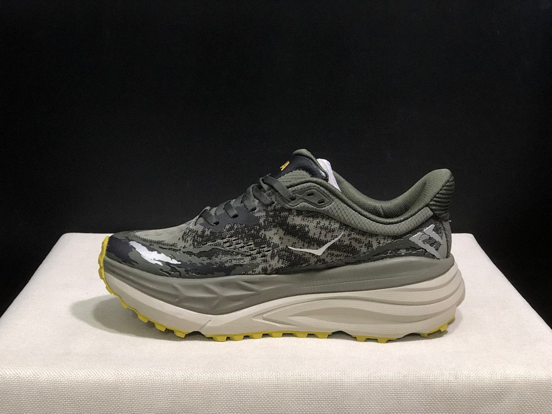HOKA Stinson 7 Trail Running Shoes, in Gray and Yellow - product image from the listing.